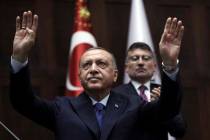 Turkish President Recep Tayyip Erdogan gestures as he addresses his ruling party legislators at ...