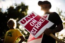 In a Sept. 16, 2019 file photo, union members picket outside a General Motors facility in Langh ...