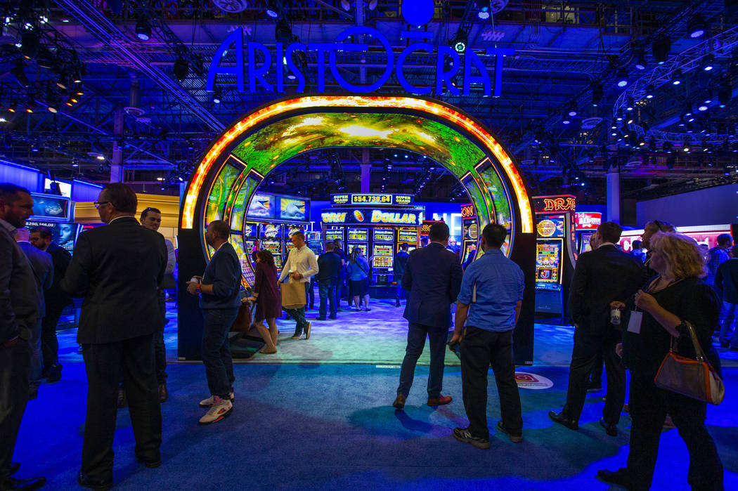 Attendees wander about the Aristocrat exhibition space entrance during the Global Gaming Expo 2 ...