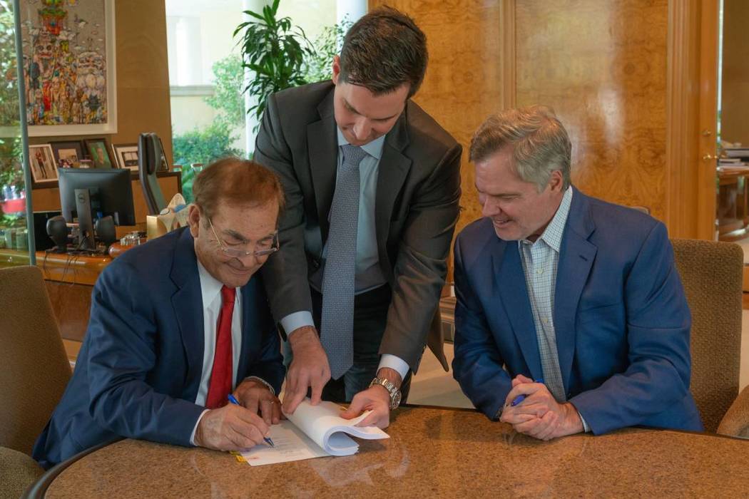 Phil Ruffin, left, signs a deal to purchase Circus Circus from MGM Resorts International alongs ...