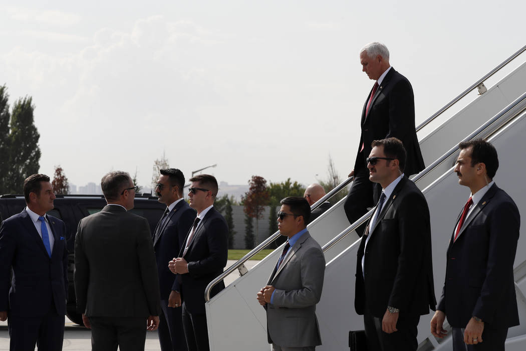 Security officers stand by Vice President Mike Pence arriving in Ankara, Turkey, Thursday, Oct. ...