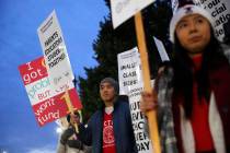Striking teachers and supporters walk a picket line outside Lane Tech High School, in Chicago, ...
