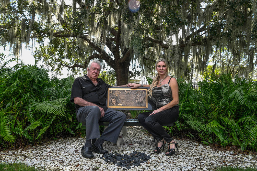 David and Jackie Siegel sit on a memorial bench made for their daughter Victoria in the backyar ...