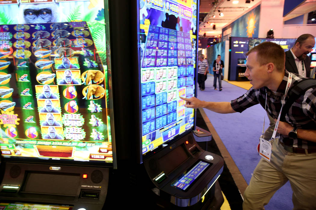Kyle Sadlik of Hunt Valley, Md. plays Money Roll at the Incredible Technologies booth at the 20 ...