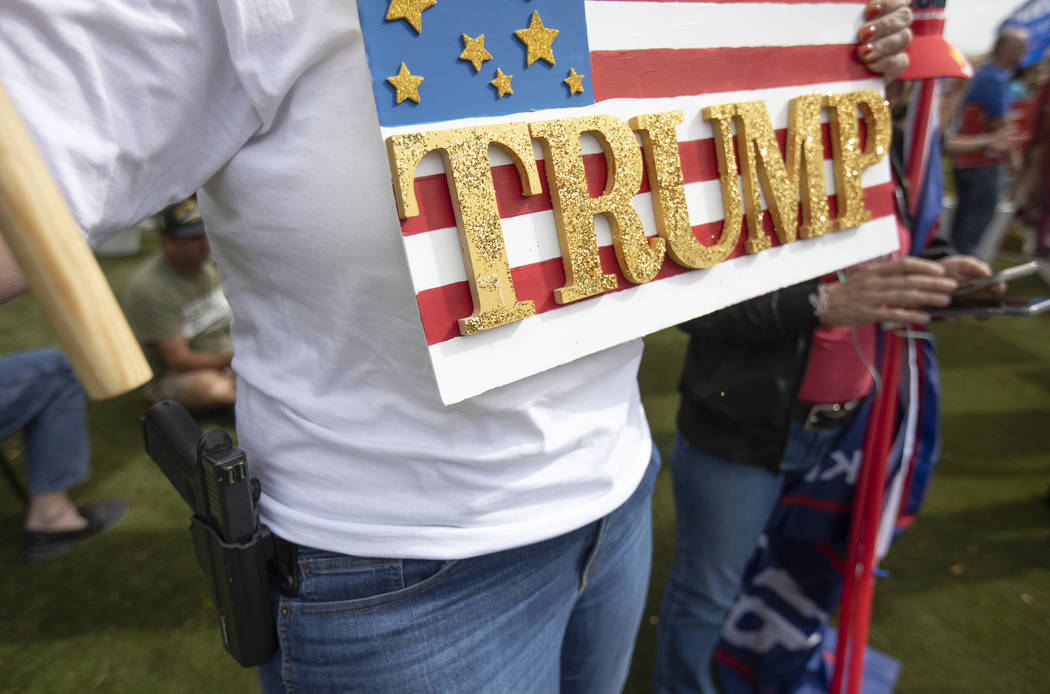 Stacie Hiebert of Pahrump carries a fire arm at the March for Trump on Thursday, Oct. 17, 2019, ...