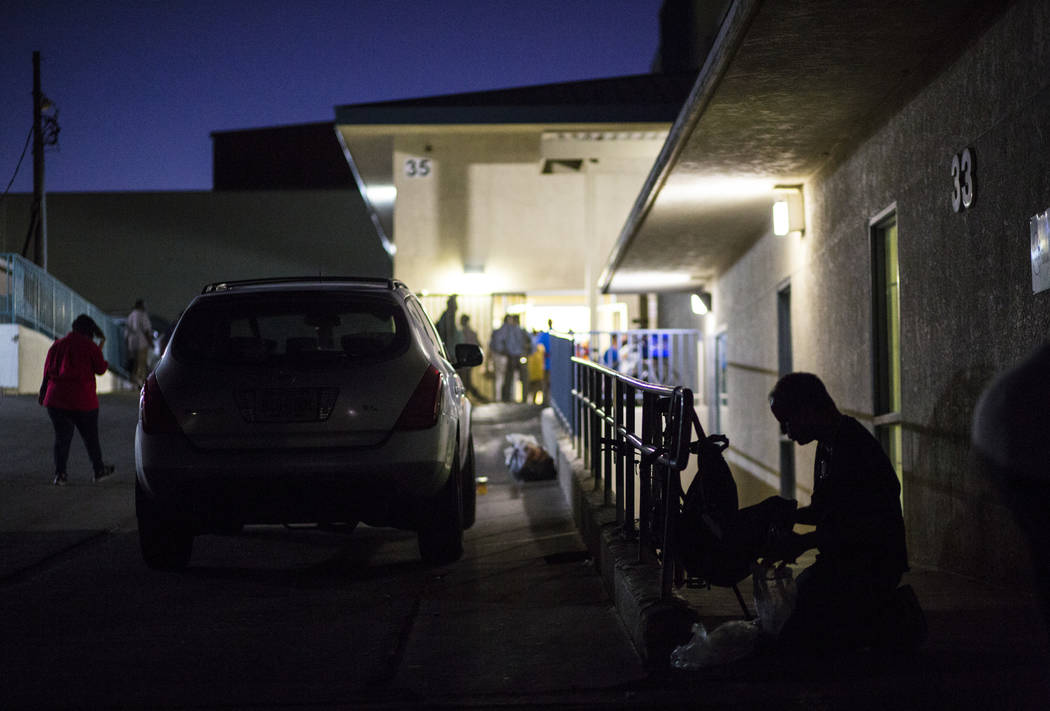 A patron of The Salvation Army homeless shelter, right, checks his belongings at the shelter ne ...