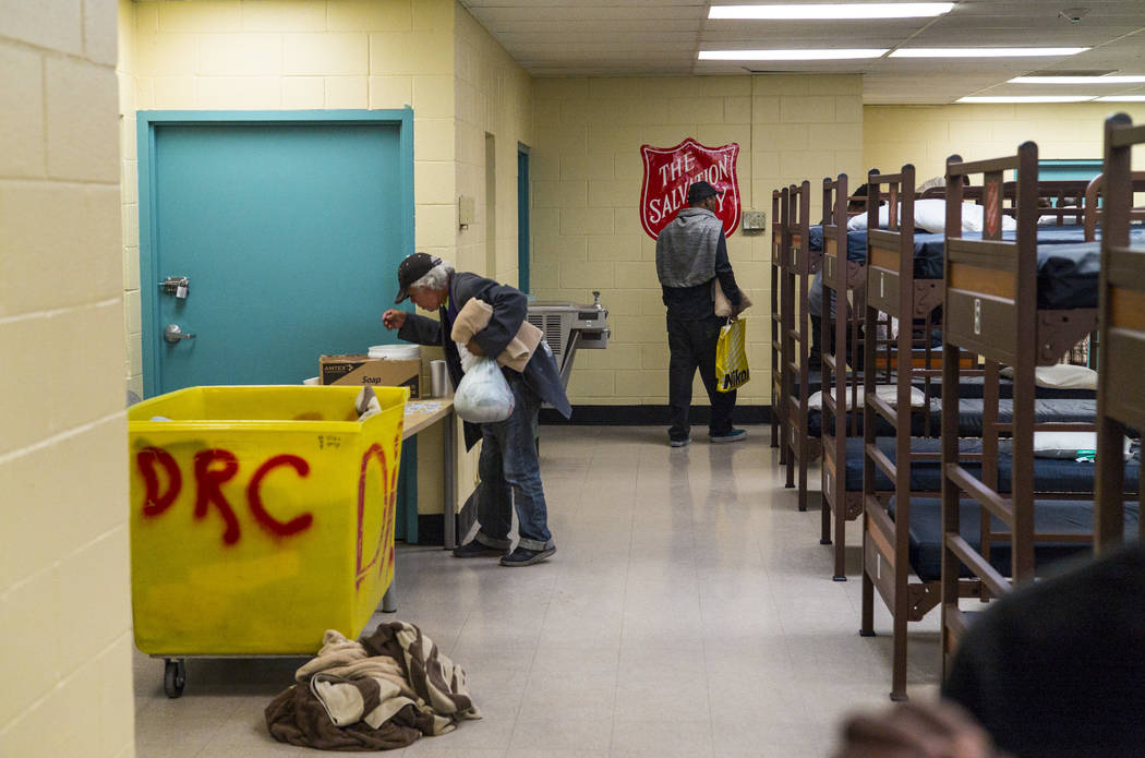 Patrons of The Salvation Army homeless shelter grab supplies near downtown Las Vegas on Tuesday ...