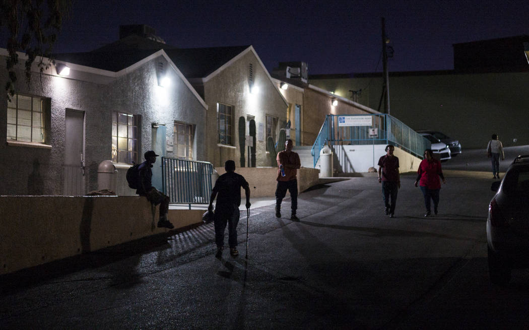 Patrons of The Salvation Army homeless shelter, including Anthony Lowe, second from left, walk ...