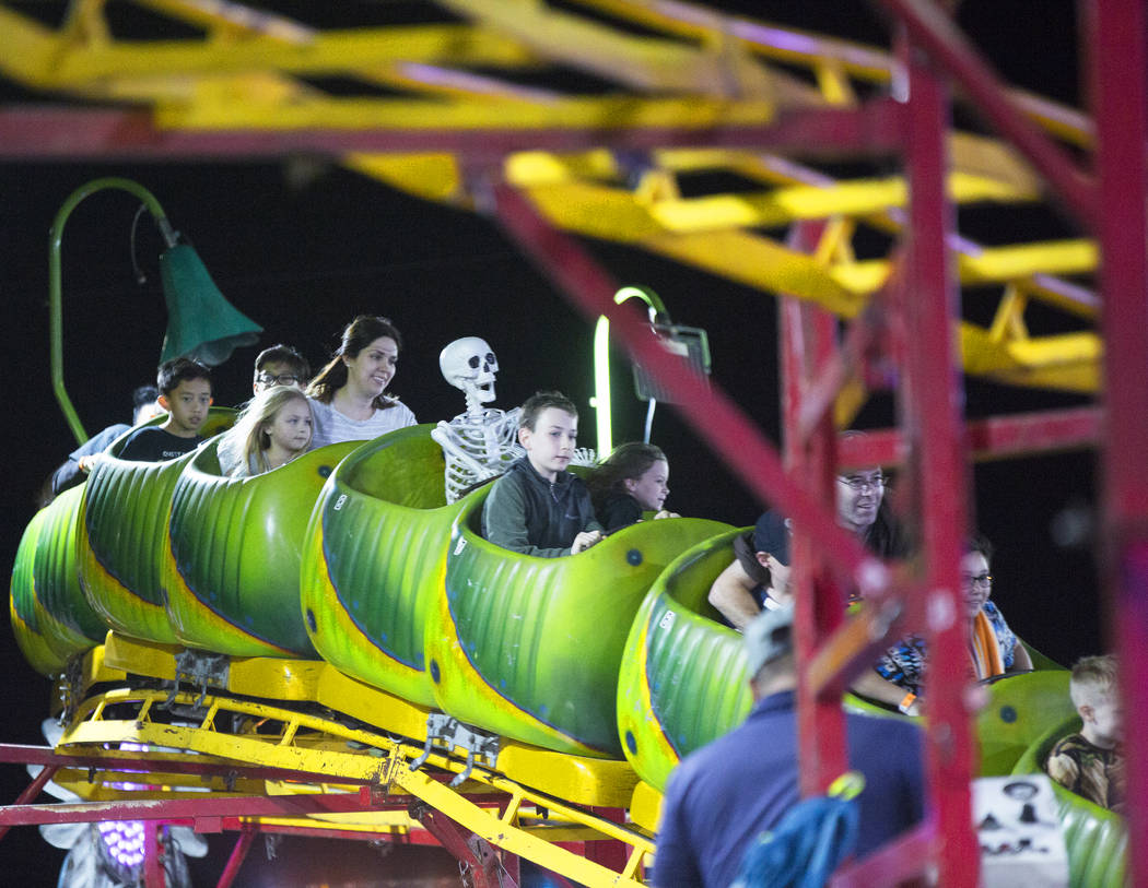 Attendees enjoy the Wacky Worm Coaster at HallOVeen on Monday, Oct. 22, 2018, at Opportunity ...