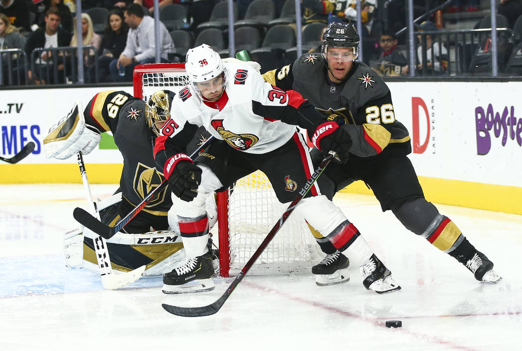 Ottawa Senators' Colin White (36) and Golden Knights' Paul Stastny (26) battle for the puck dur ...