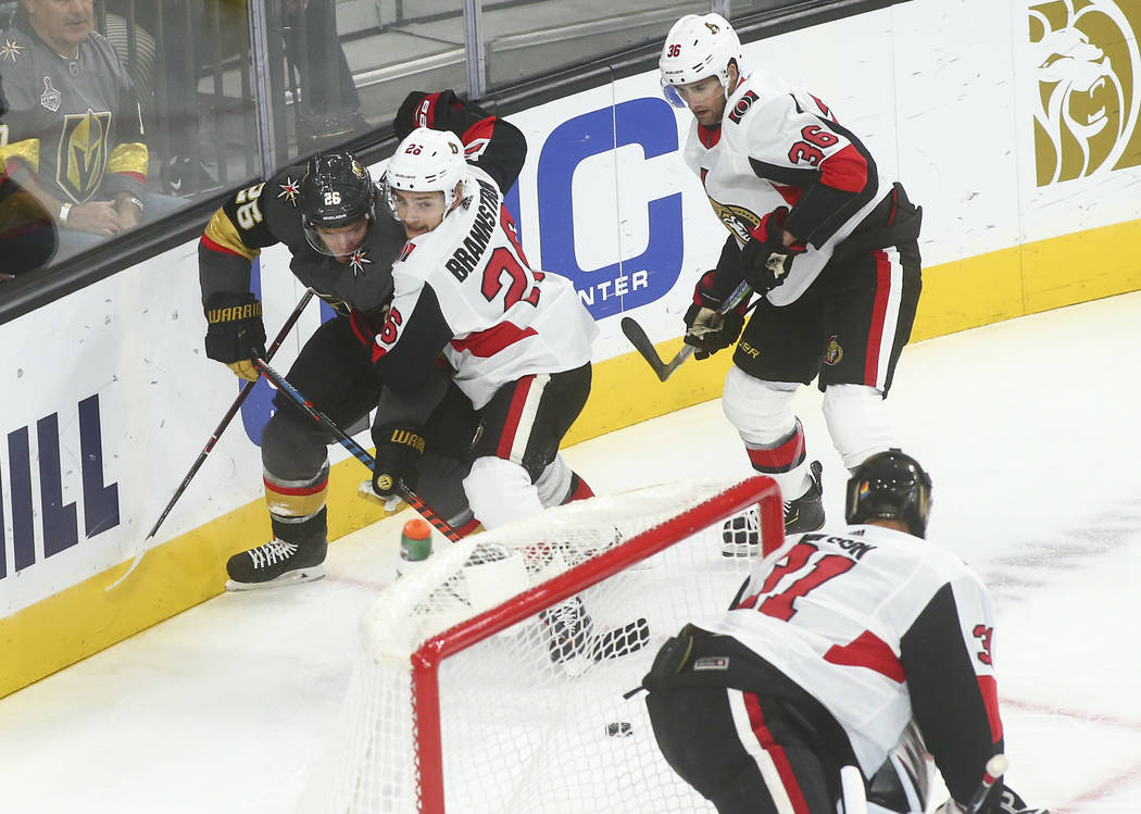 Golden Knights' Paul Stastny, left, battles for the puck against Ottawa Senators' Erik Brannstr ...