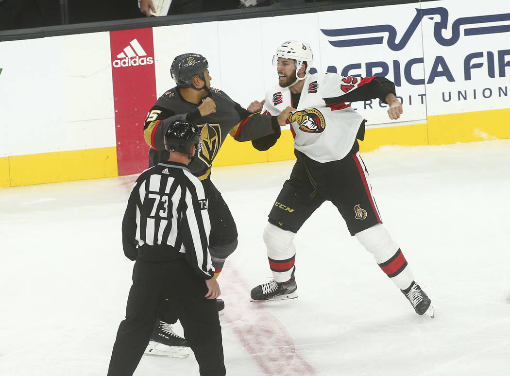 Golden Knights' Ryan Reaves (75) fights Ottawa Senators' Scott Sabourin (49) during the first p ...