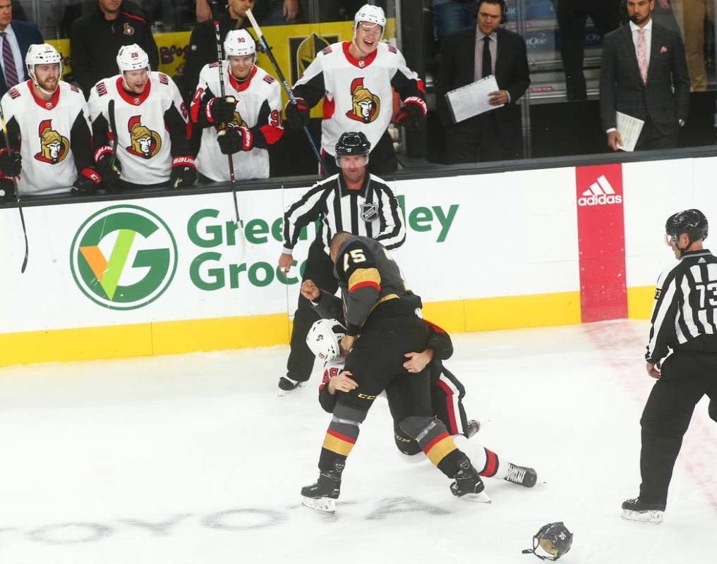 Golden Knights' Ryan Reaves (75) fights Ottawa Senators' Scott Sabourin (49) during the first p ...