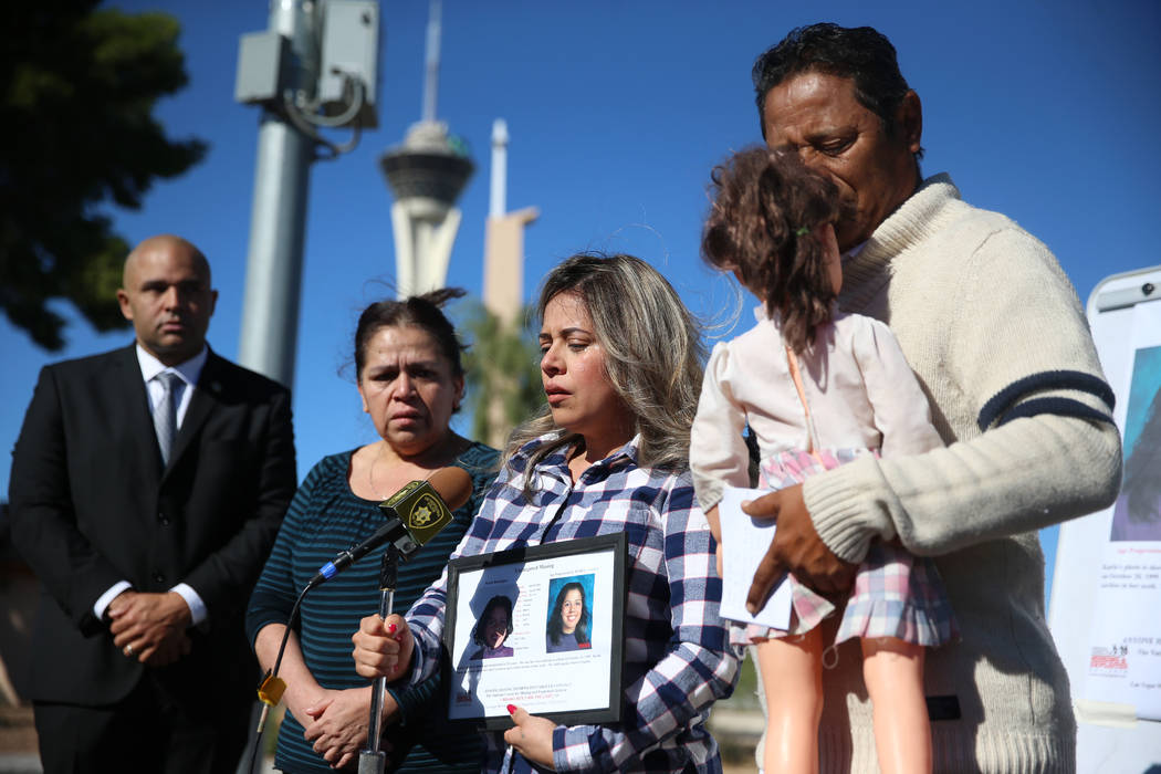 Las Vegas police Lt. Raymond Spencer, far left, listens to Rosy Rodriguez, center, with her par ...
