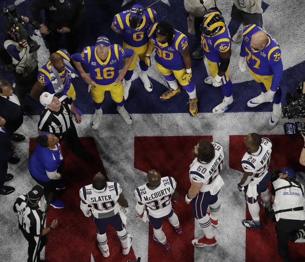 Referee John Parry and players watch the coin toss before the NFL Super Bowl 53 football game b ...
