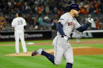 Houston Astros' George Springer, right, celebrates after his three-run home run off New York Ya ...