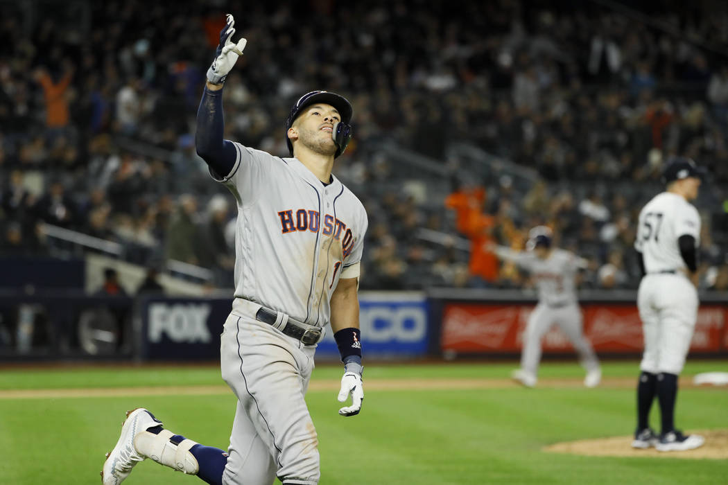 Houston Astros' Carlos Correa, left, celebrates his three-run home run off New York Yankees rel ...