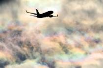A Southwest Airlines plane flies under a rainbow sky as it approaches McCarran International Ai ...