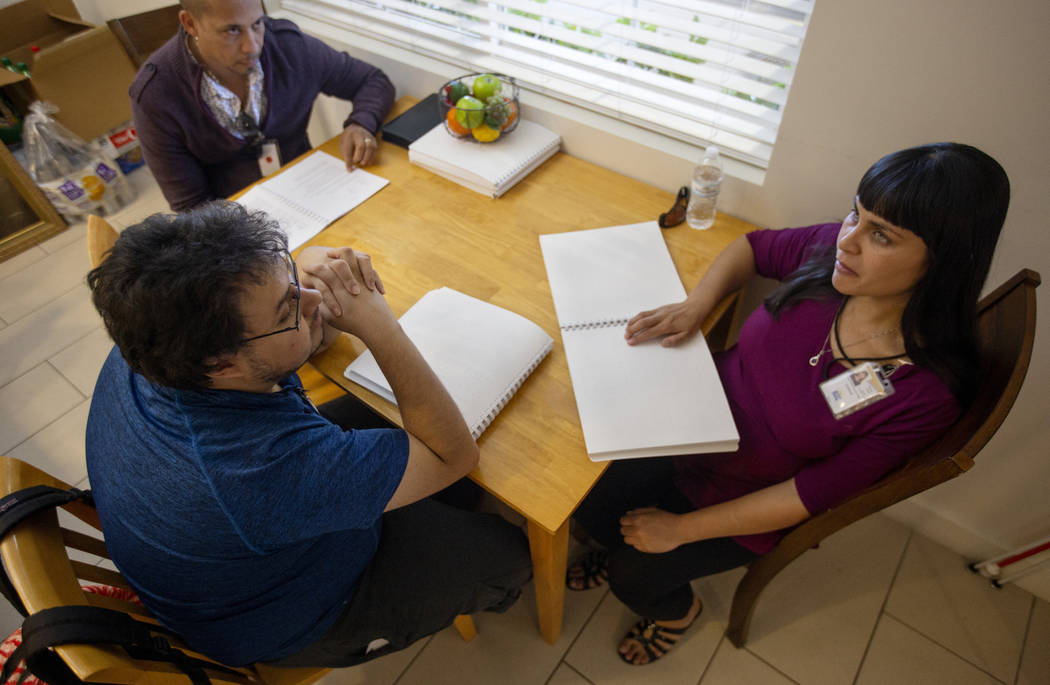 BlindConnect President Raquel O'Neill, right, goes through a Braille lesson with Ivan Medina, c ...