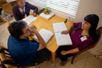 BlindConnect President Raquel O'Neill, right, goes through a Braille lesson with Ivan Medina, c ...