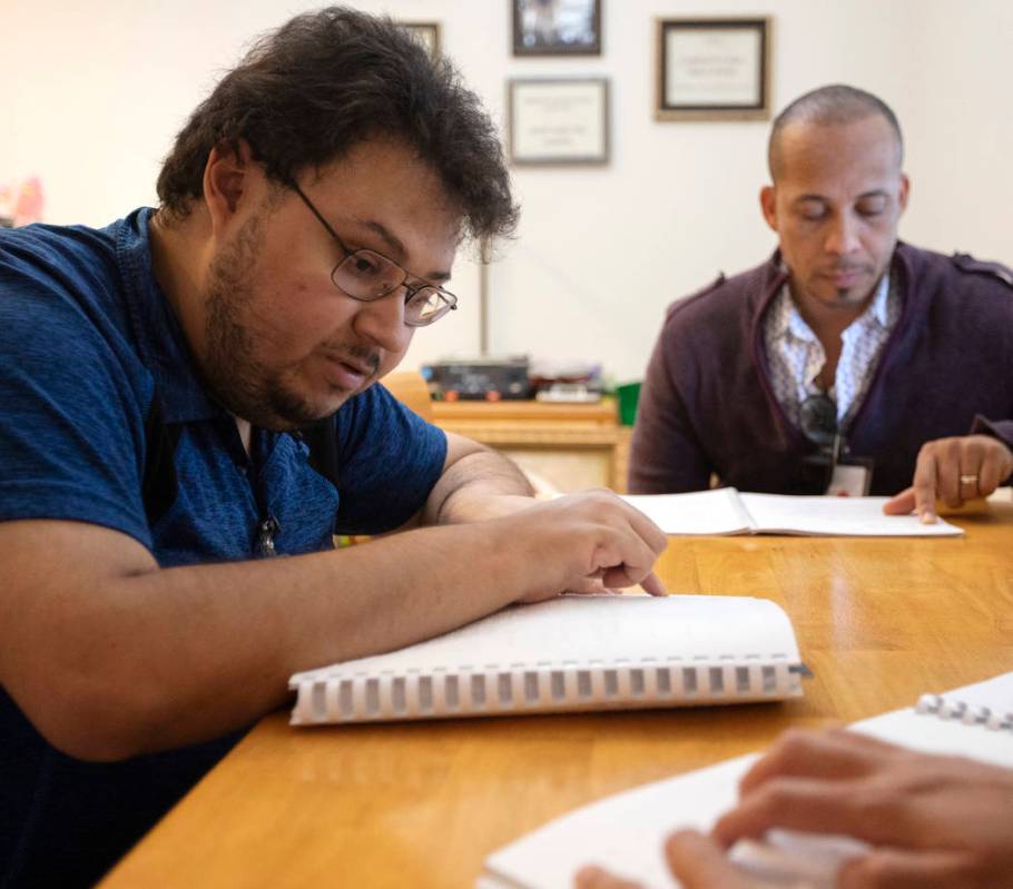 Ivan Medina, left, who is visually impaired due to retina pigmentosa, learns Braille on Friday, ...