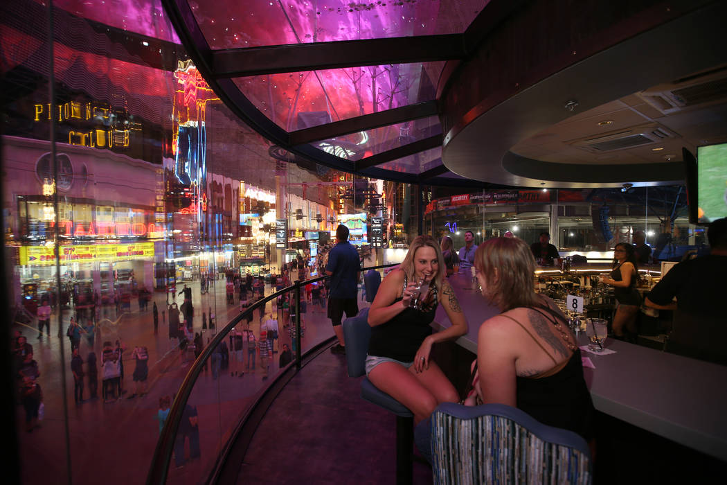 Trista Wells, left, and Sara Peterson, both of Kalispell Montana, at the rotating bar at Whiske ...