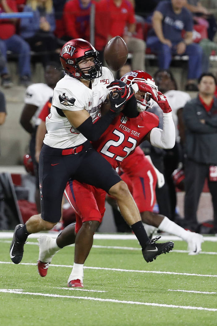 UNLV wide receiver Jacob Gasser, left, tries to haul in a pass that was eventually intercepted, ...