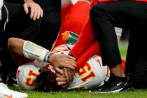 Kansas City Chiefs quarterback Patrick Mahomes (15) is helped by trainers after getting injured ...