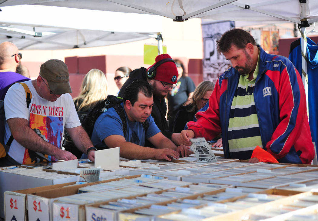 Comic book fans dig through boxes of comic books at the 11th annual Vegas Valley Comic Book Fes ...