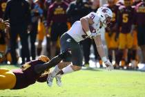 Washington State running back Max Borghi (21) is pulled down by Arizona State linebacker Darien ...