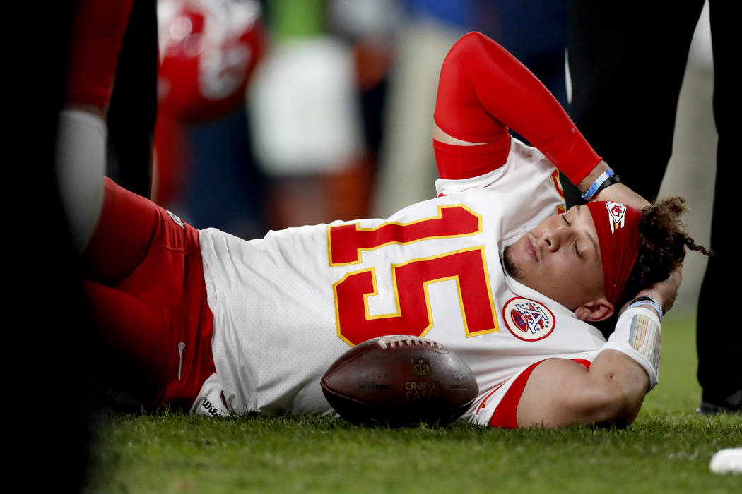 Kansas City Chiefs quarterback Patrick Mahomes (15) lies on the field after being injured again ...