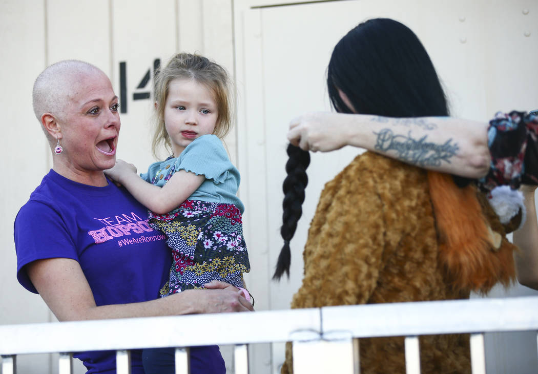 Jessica Hopson, left, holding her daughter, Willow, 3, reacts after the hair of Ronnow Elementa ...