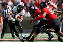 Oklahoma State's Chuba Hubbard (30) runs with the ball during the first half of the NCAA colleg ...