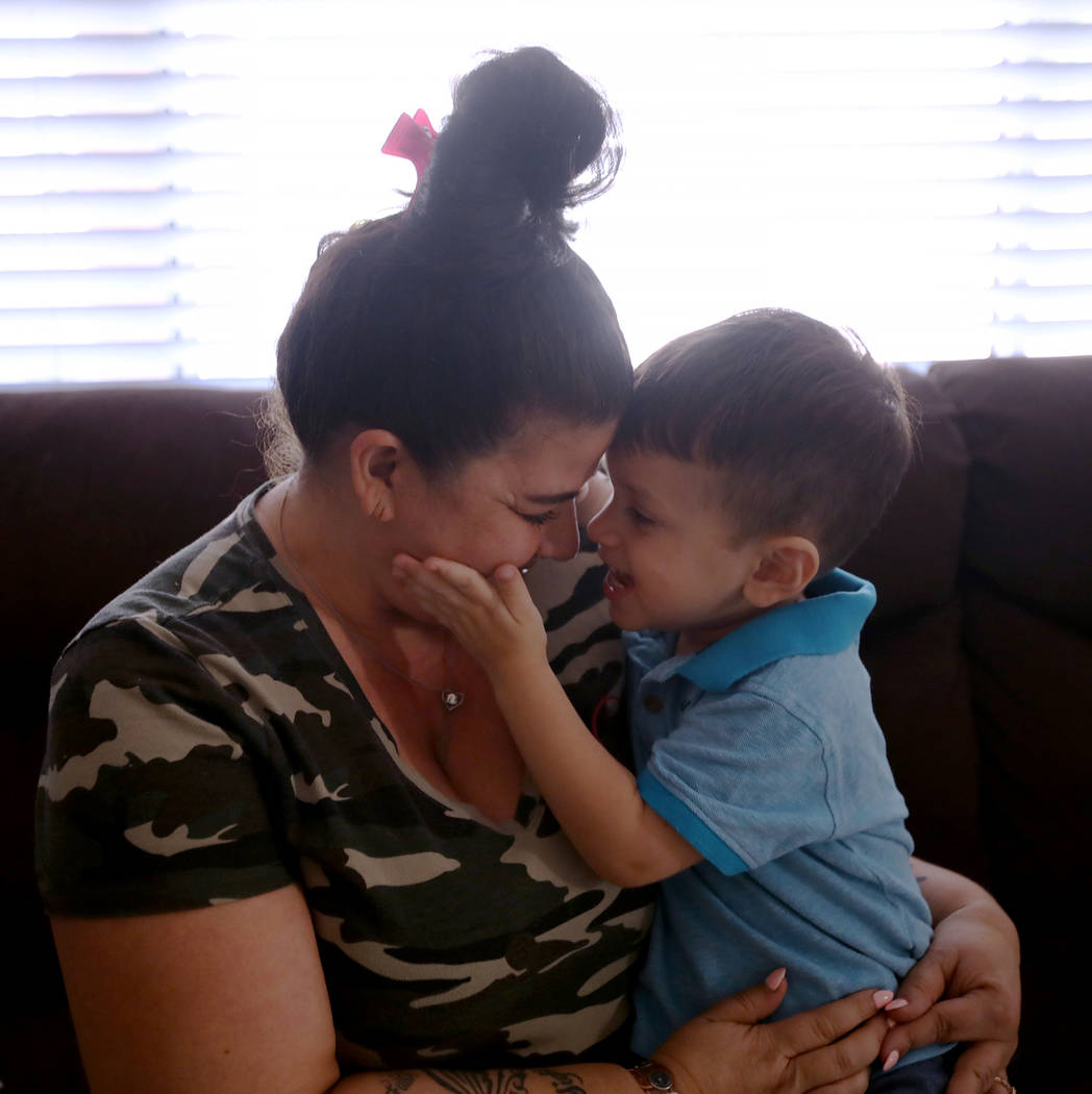 Hanna Olivas cuddles with her grandchild Dominic Camacho, 2, at her home in Las Vegas, Wednesda ...