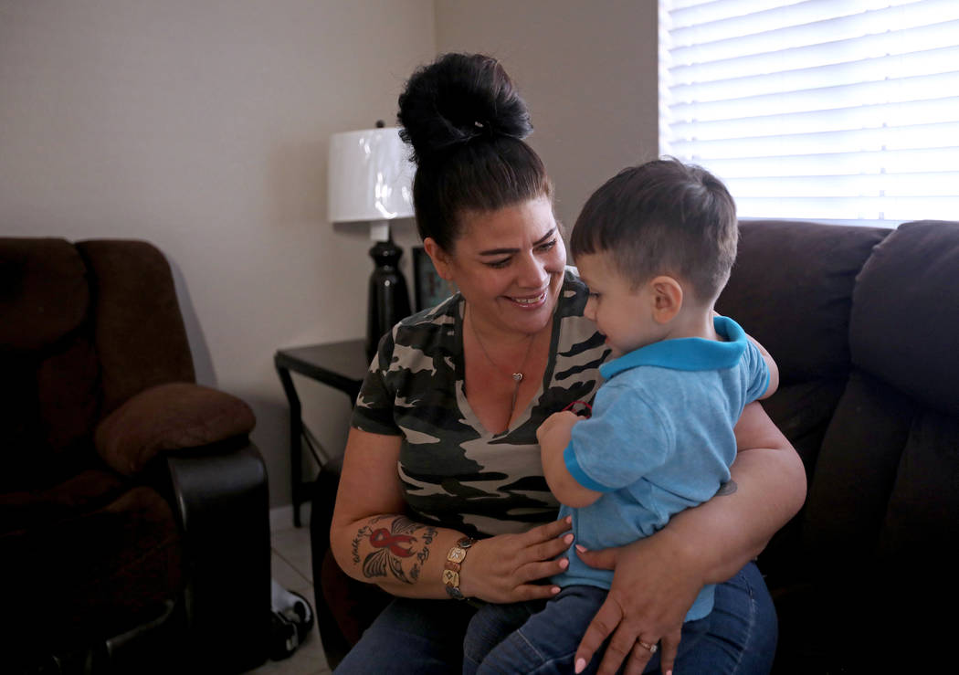 Hanna Olivas cuddles with her grandchild Dominic Camacho, 2, at her home in Las Vegas, Wednesda ...