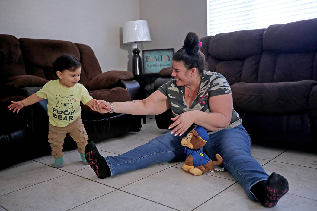 Hanna Olivas plays with her grandchild Damian Cordova, 1, at her home in Las Vegas, Wednesday, ...