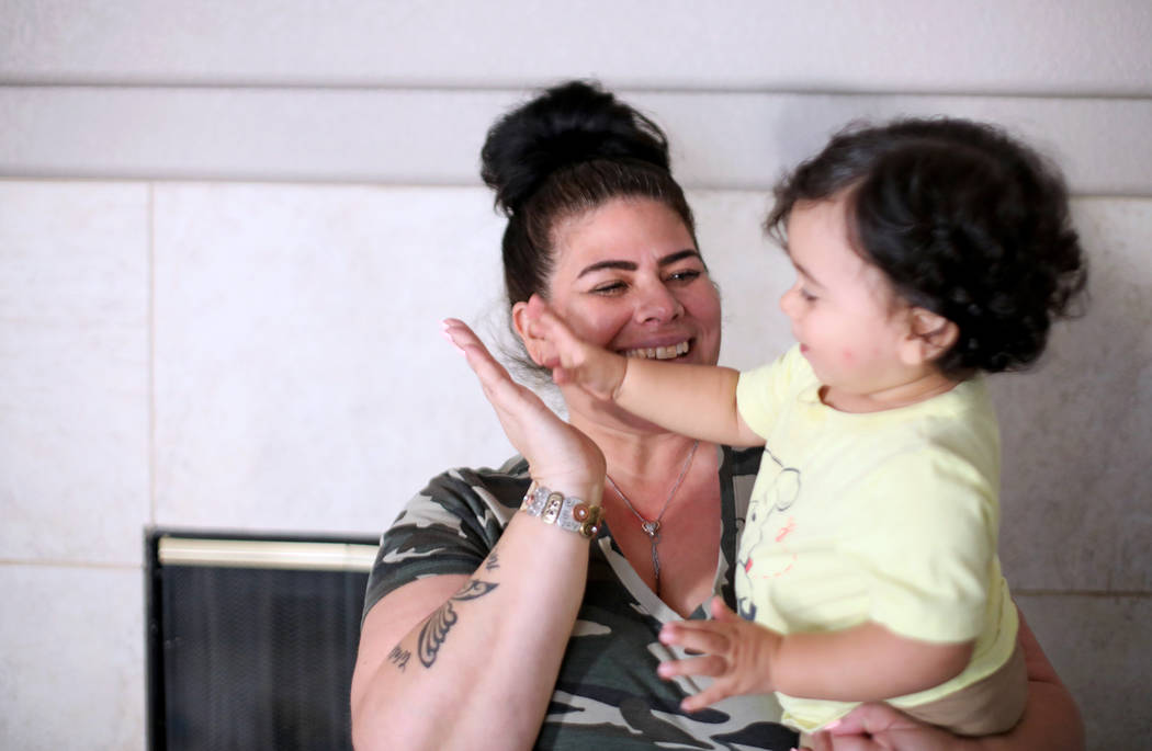 Hanna Olivas plays with her grandchild Damian Cordova, 1, at her home in Las Vegas, Wednesday, ...
