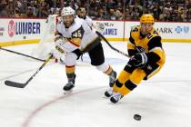 Vegas Golden Knights' Jake Bischoff (45) and and Pittsburgh Penguins' Dominik Kahun (24) chase ...