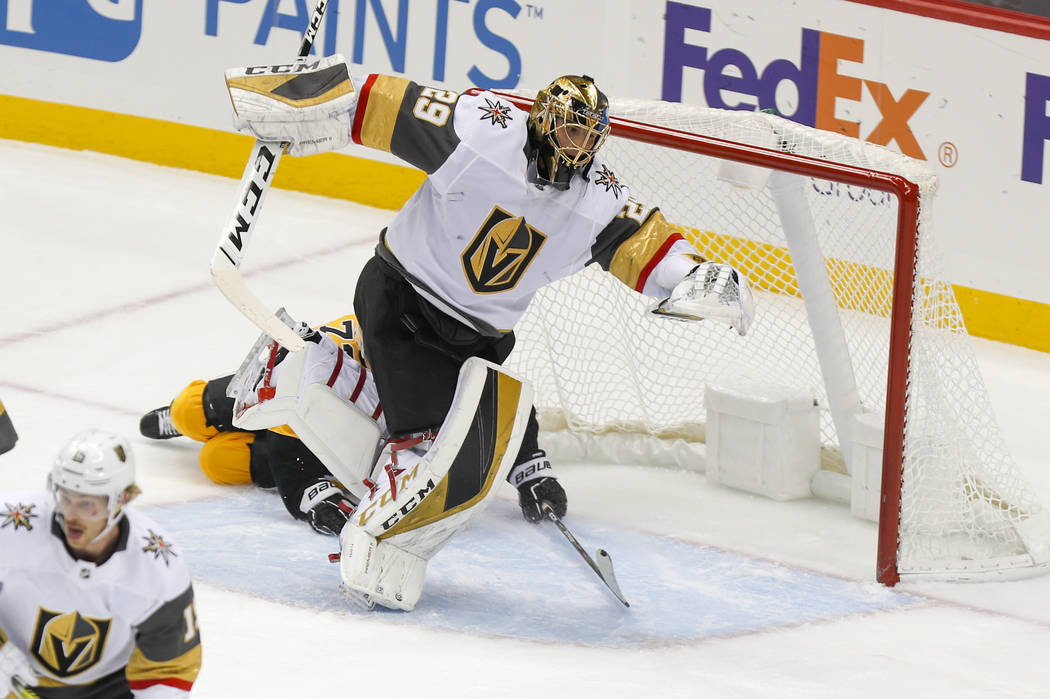 Vegas Golden Knights goaltender Marc-Andre Fleury (29) twists out of the way as Pittsburgh Peng ...