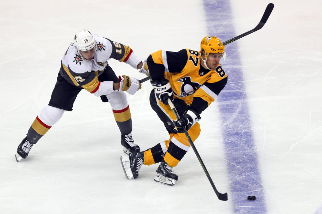 Pittsburgh Penguins' Sidney Crosby (87) takes the puck past Vegas Golden Knights' Reilly Smith ...