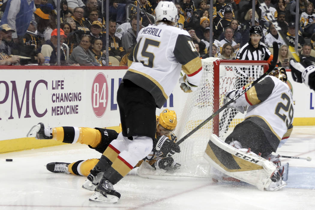 Pittsburgh Penguins' Zach Aston-Reese, bottom left, slides past Vegas Golden Knights goaltender ...