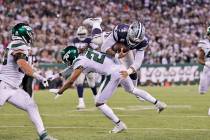 Dallas Cowboys quarterback Dak Prescott, top, runs the ball during the second half of an NFL fo ...