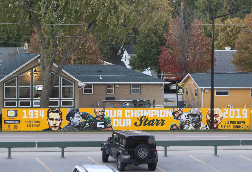 Signage on homes across the street from Lambeau Field in Green Bay, Wis., Friday, Oct. 18, 201 ...