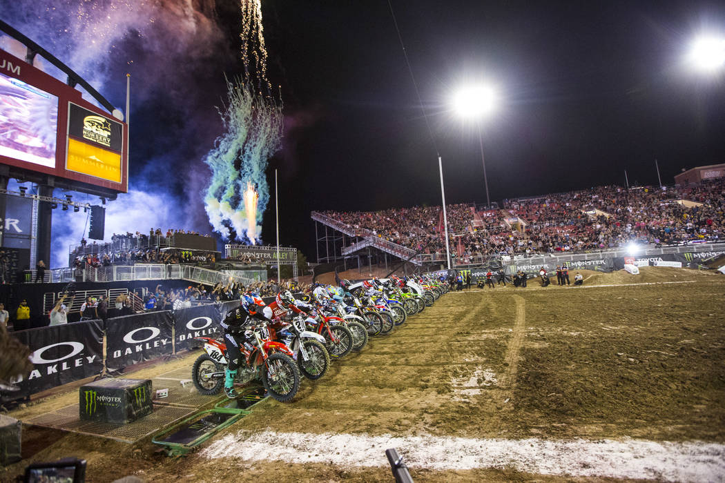 Riders begin the first lap of the first round of the Monster Energy Cup Supercross main event a ...