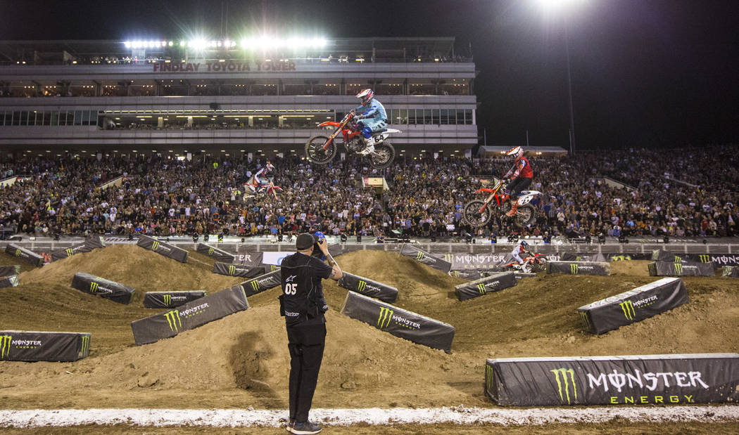 Riders compete during the first round of the Monster Energy Cup Supercross main event at Sam Bo ...