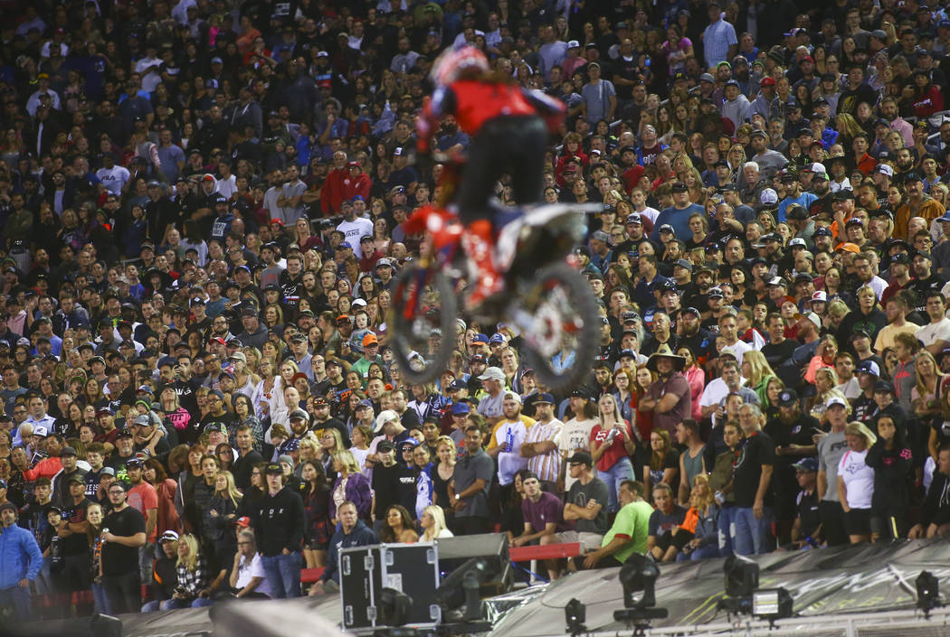 Fans watch as Malcolm Stewart (27) competes during the second round of the Monster Energy Cup S ...