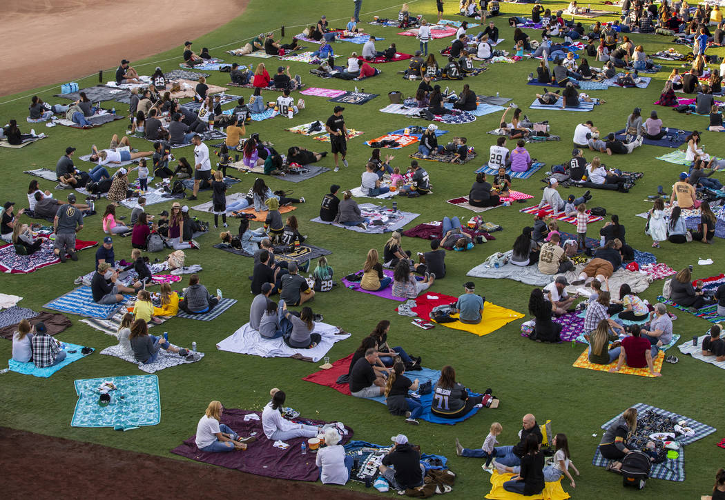 Fans relax on the field during the first Vegas Golden Knights watch party as they take on the P ...