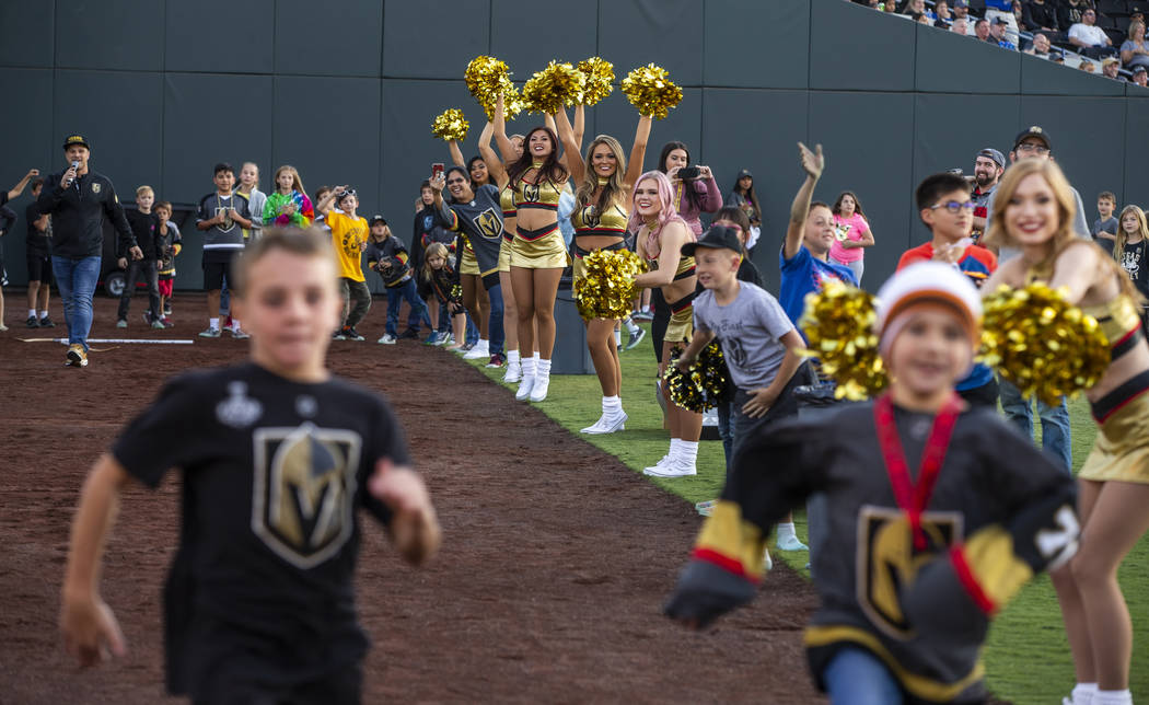 Vegas Golden Knights cheerleaders urge on contest runners during the first Vegas Golden Knights ...