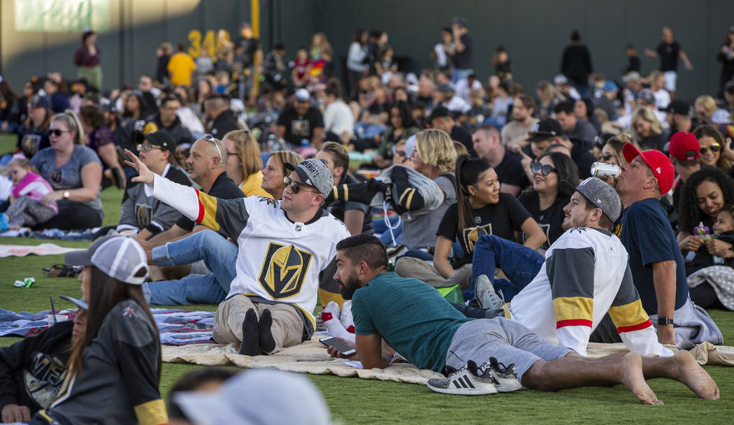 Fans relax on the field during the first Vegas Golden Knights watch party as they take on the P ...