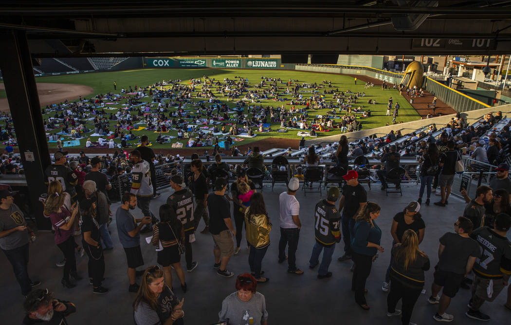 Fans relax on the field and in the stands during the first Vegas Golden Knights watch party as ...